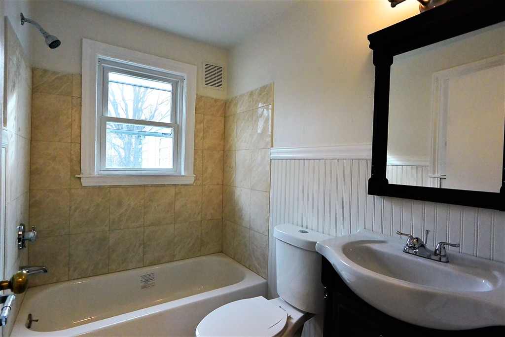 6 Arnold Road Peabody, MA 01960 - Photo 9 of 24 a bathroom with a sink and a bathtub
