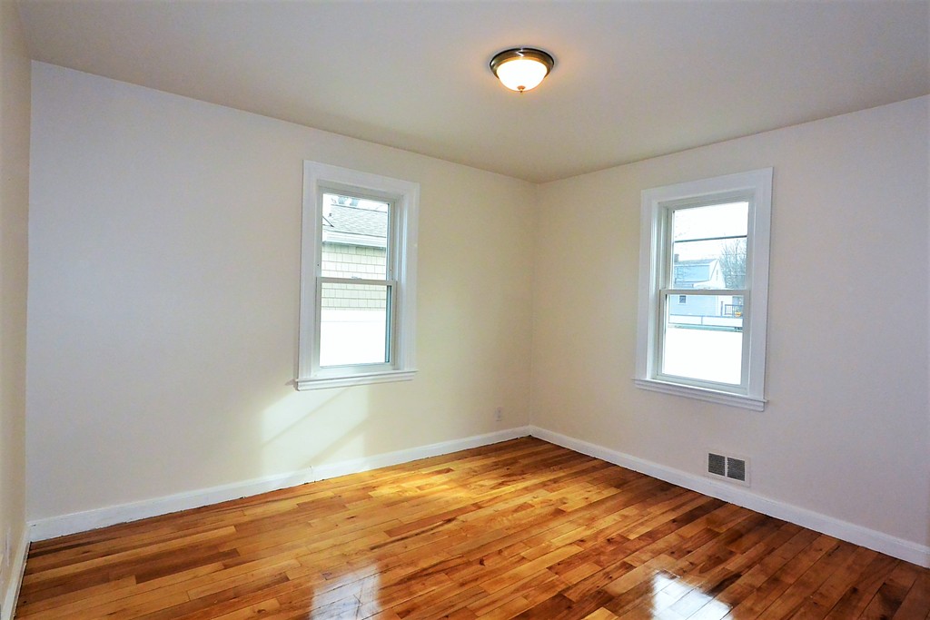 6 Arnold Road Peabody, MA 01960 - Photo 10 of 24 an empty room with wooden floor and windows