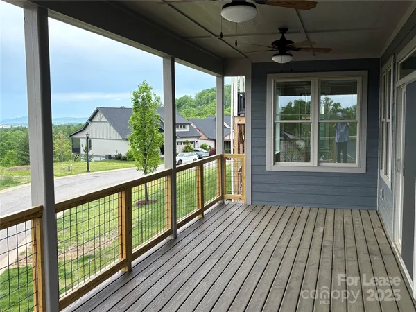 a view of outdoor space with wooden floor and windows