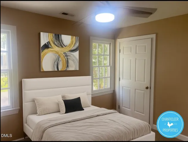 a bedroom with a bed and painting on the wall