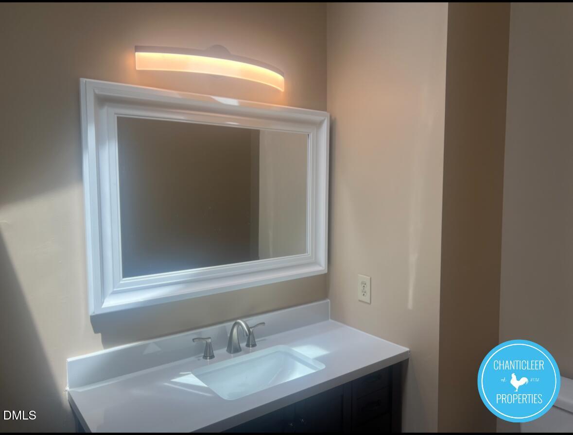 6923 Sandringham Drive Raleigh, NC 27613 - Photo 13 of 16 a bathroom with a sink and a mirror
