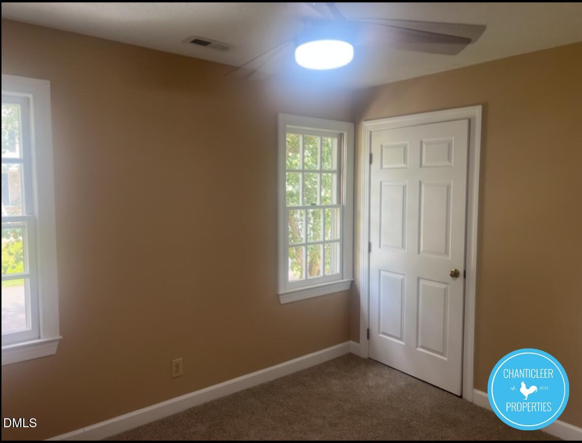 6923 Sandringham Drive Raleigh, NC 27613 - Photo 14 of 16 an empty room with windows
