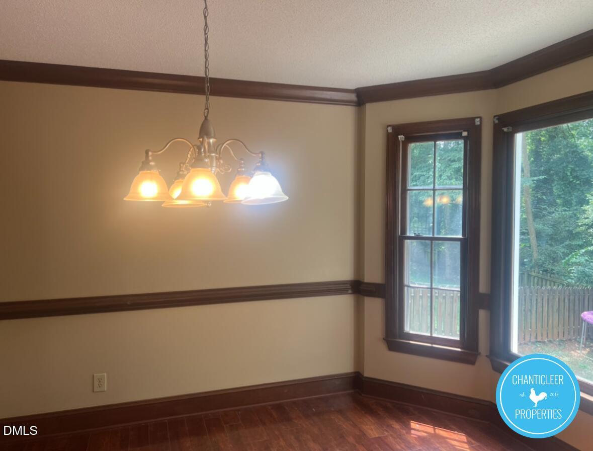 6923 Sandringham Drive Raleigh, NC 27613 - Photo 6 of 16 a view of a room with wooden floor and windows