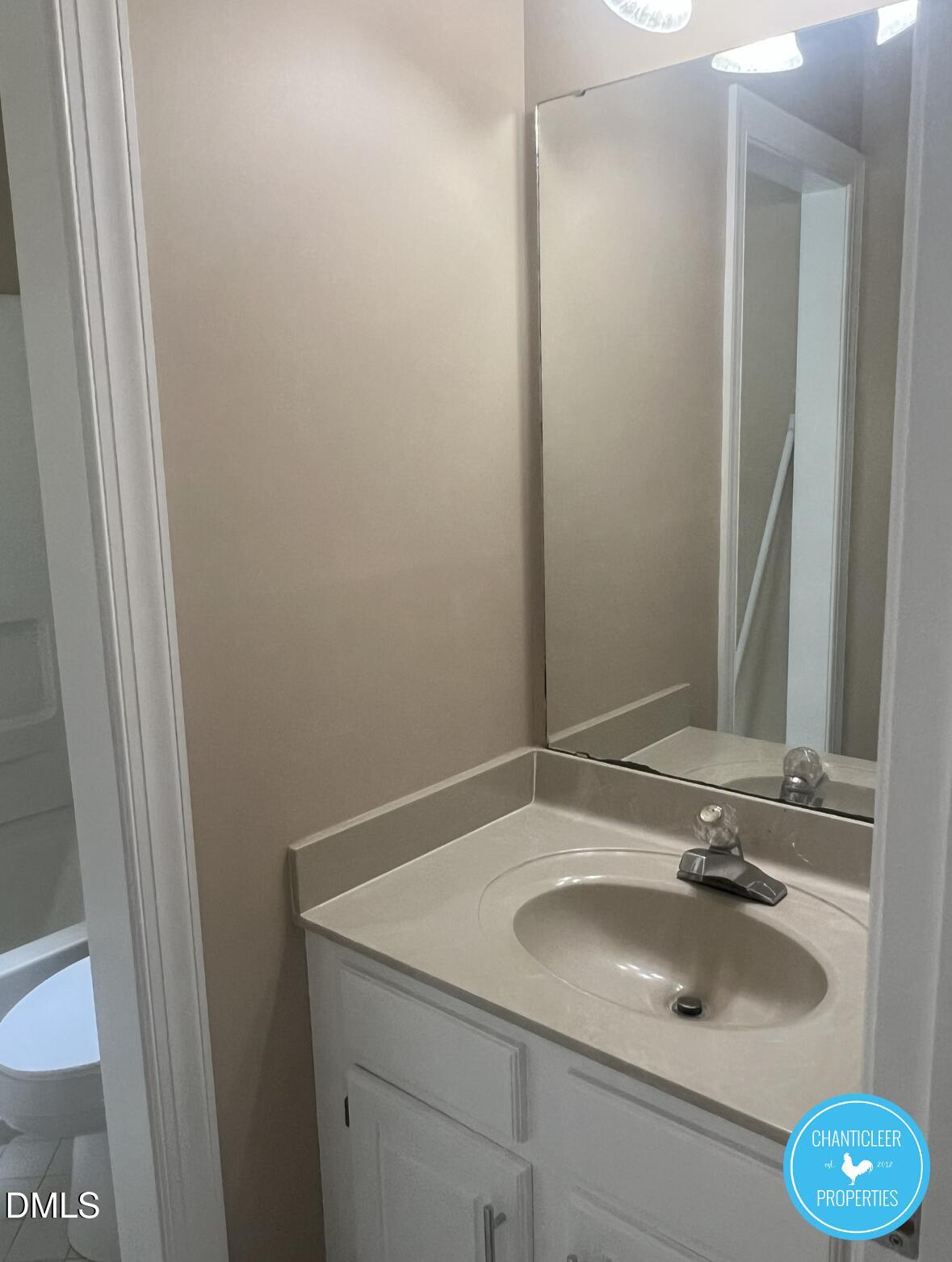 6923 Sandringham Drive Raleigh, NC 27613 - Photo 8 of 16 a bathroom with a sink and a mirror