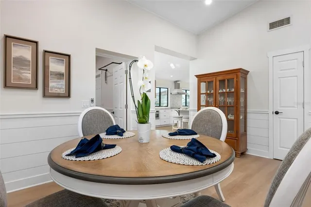 a large white kitchen with a sink and cabinets