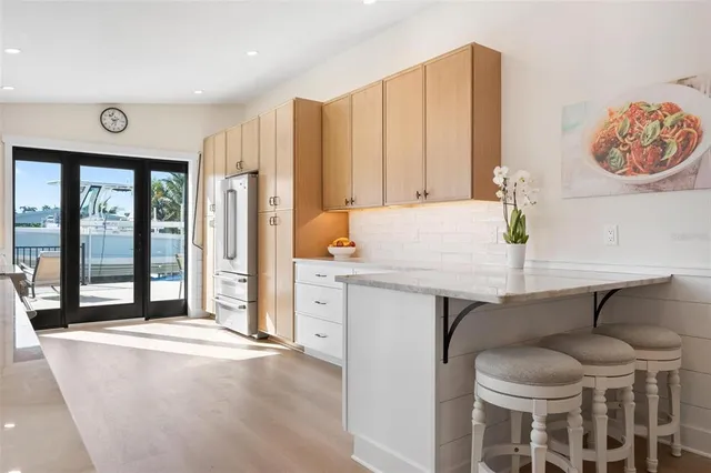 a kitchen with granite countertop white cabinets and white appliances