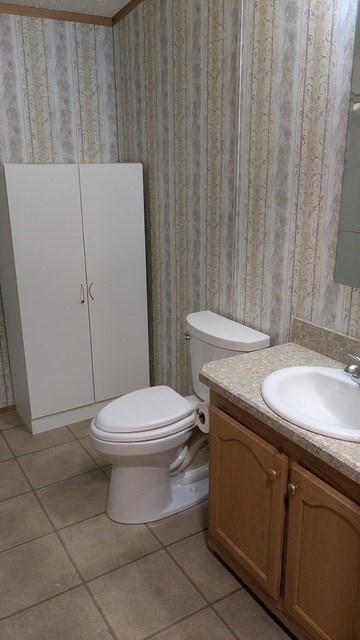 735 Memorial Drive, Unit 40 Chicopee, MA 01020 - Photo 18 of 20 a bathroom with a granite countertop toilet and a sink