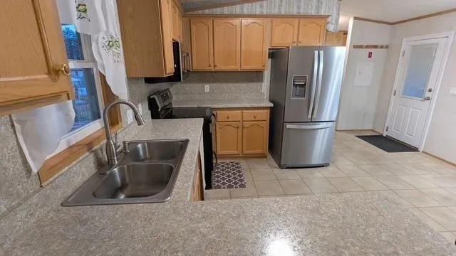 a kitchen with a refrigerator sink and stove