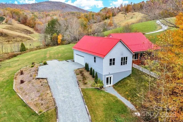a aerial view of a house with a yard
