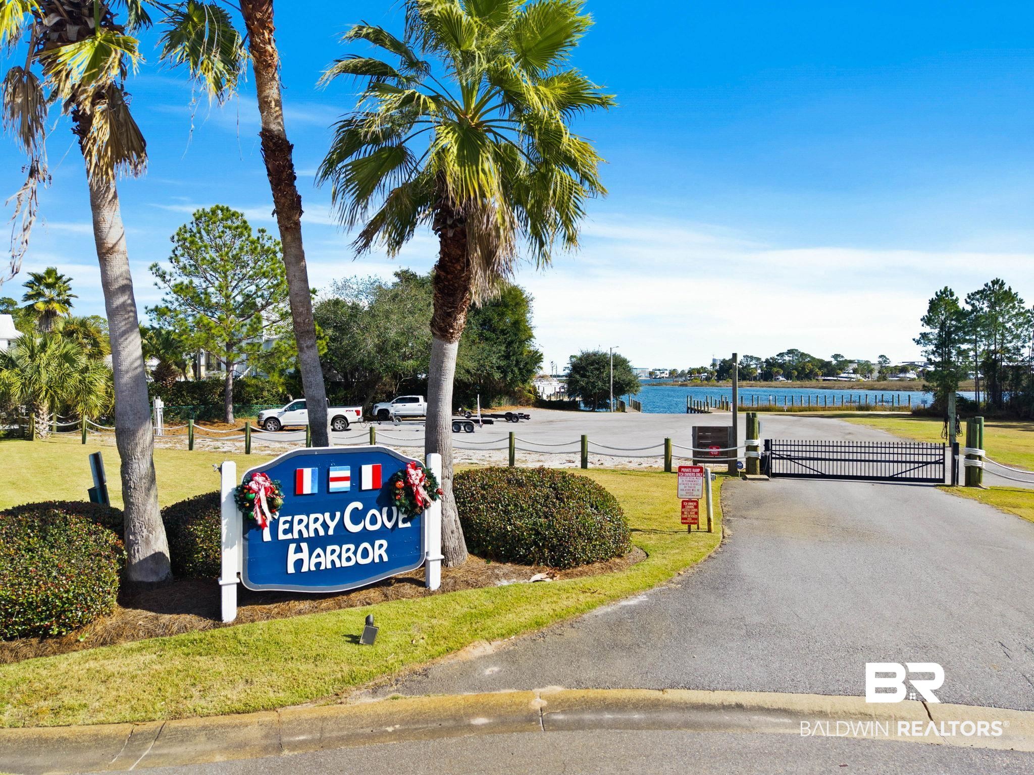 4143 Harbor Road Orange Beach, AL 36561 - Photo 23 of 33 View of asphalt road featuring a gate, a water view, and a gated entry