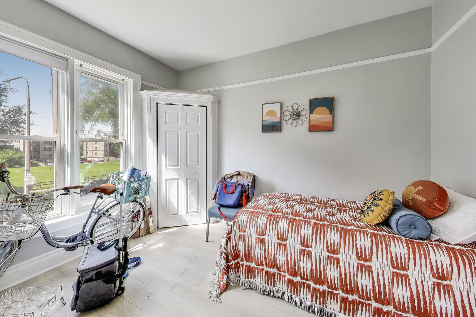 5169 South Michigan Avenue, Unit 2 Chicago, IL 60615 - Photo 13 of 21 a bedroom with two beds and a chair
