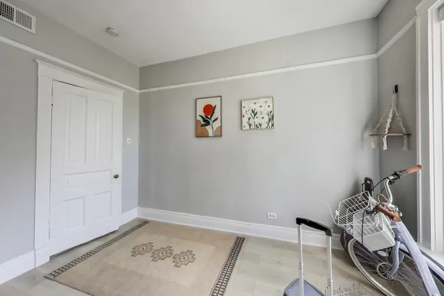 a view of a room with bed and wooden floor