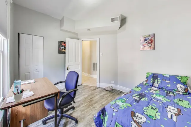 a bedroom with a bed and a table in it