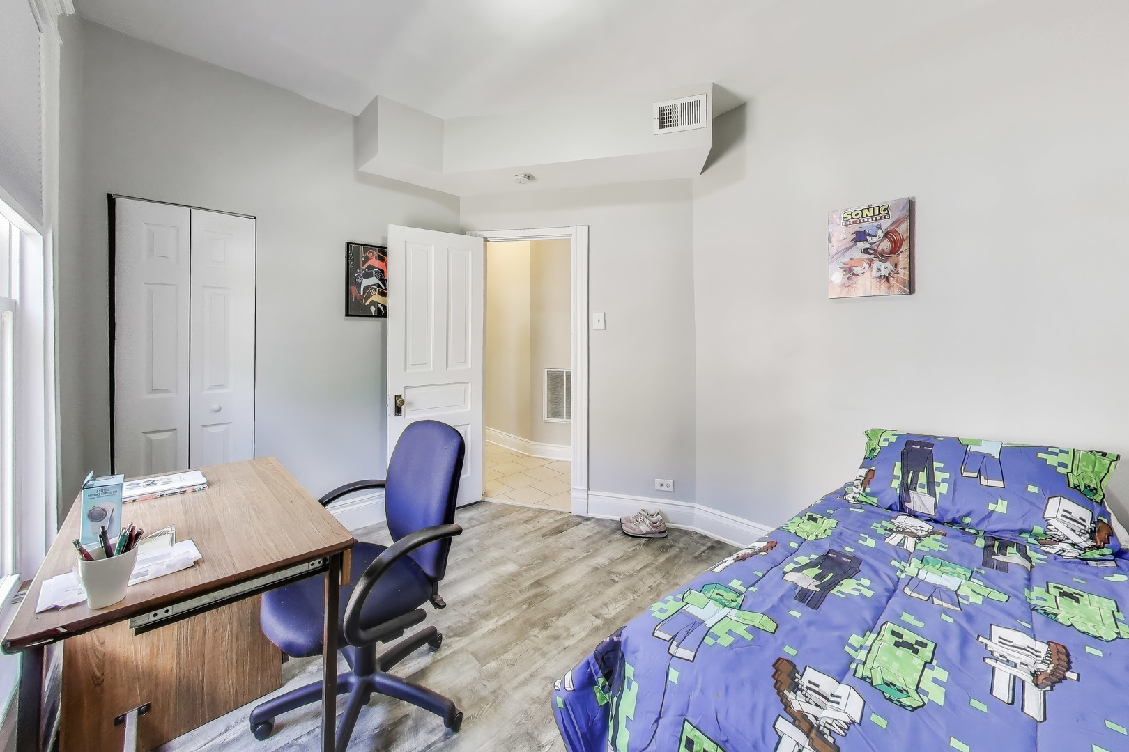 5169 South Michigan Avenue, Unit 2 Chicago, IL 60615 - Photo 16 of 21 a bedroom with a bed and a table in it