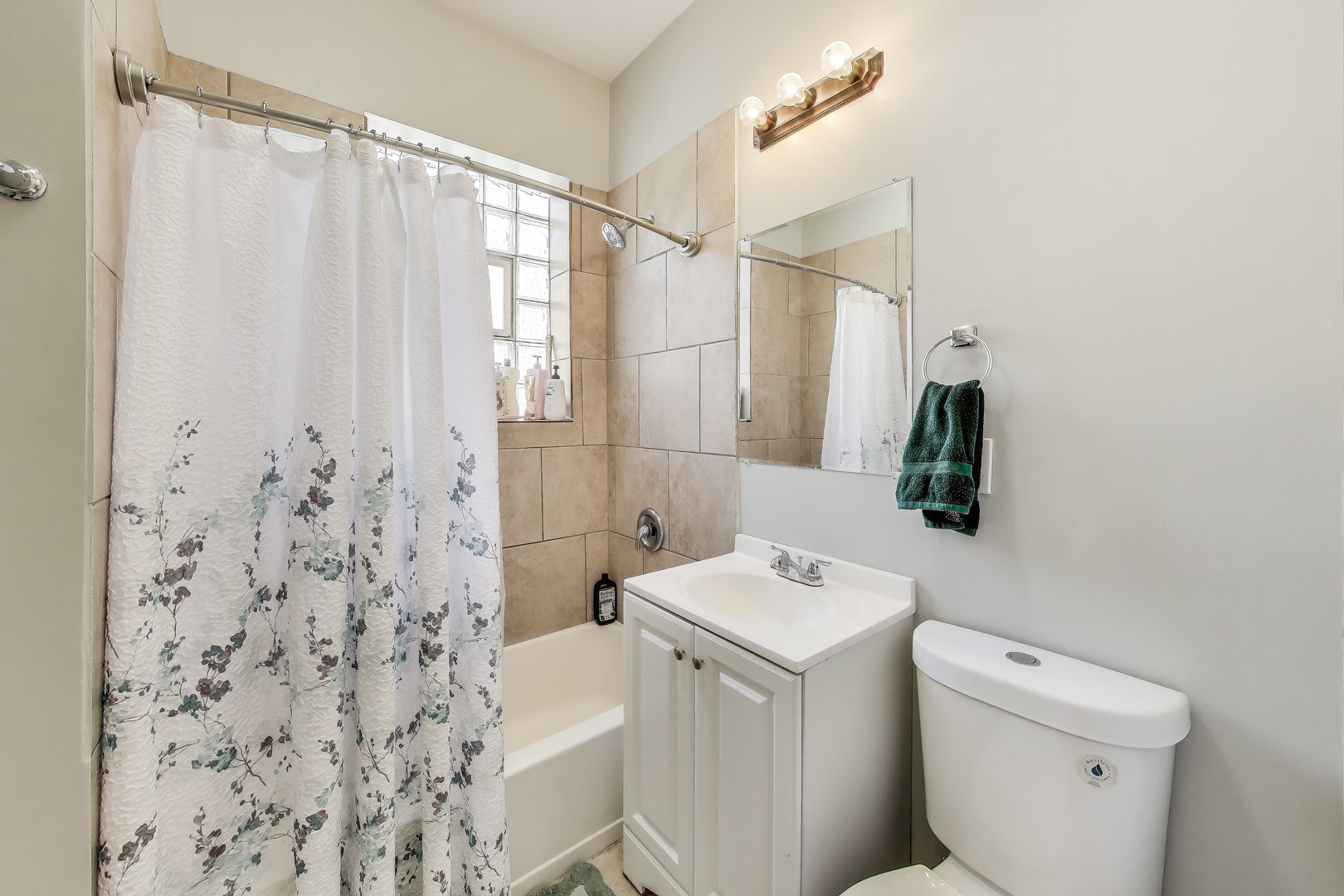 5169 South Michigan Avenue, Unit 2 Chicago, IL 60615 - Photo 17 of 21 a bathroom with a sink a toilet and shower