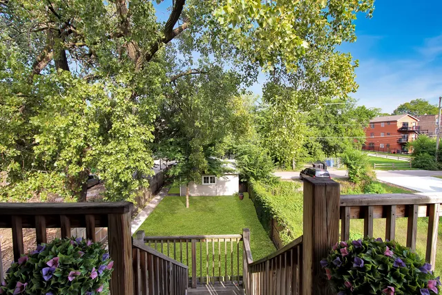 a view of a swimming pool and deck in the backyard