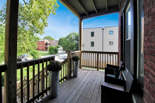 a view of a balcony with wooden floor