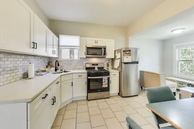 a kitchen with a sink cabinets and stainless steel appliances