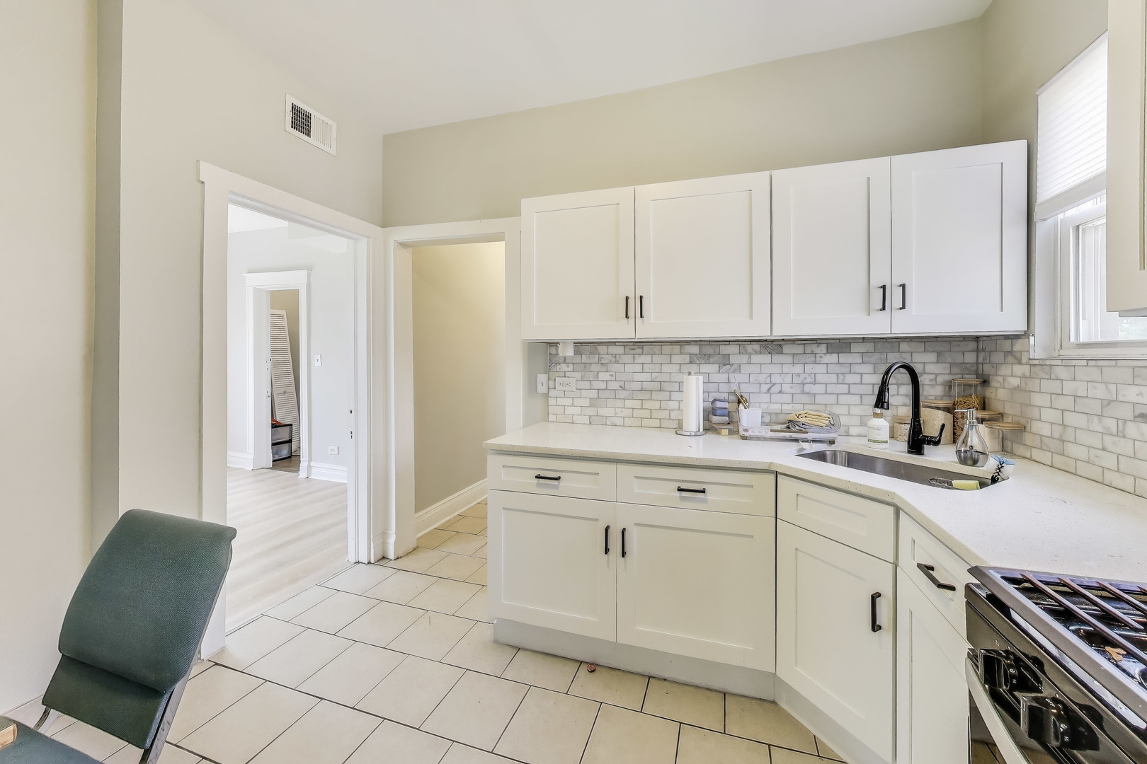 5169 South Michigan Avenue, Unit 2 Chicago, IL 60615 - Photo 6 of 21 a kitchen with stainless steel appliances granite countertop a sink and cabinets