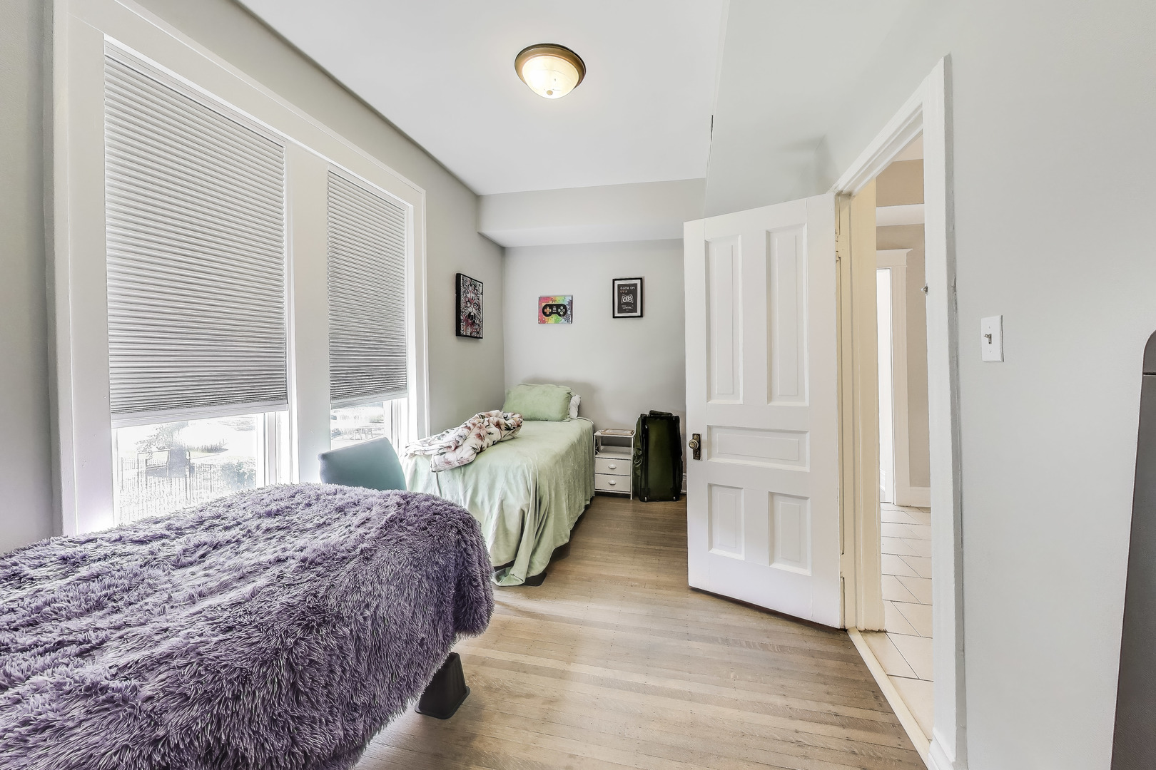 5169 South Michigan Avenue, Unit 2 Chicago, IL 60615 - Photo 9 of 21 a bedroom with a bed and a window