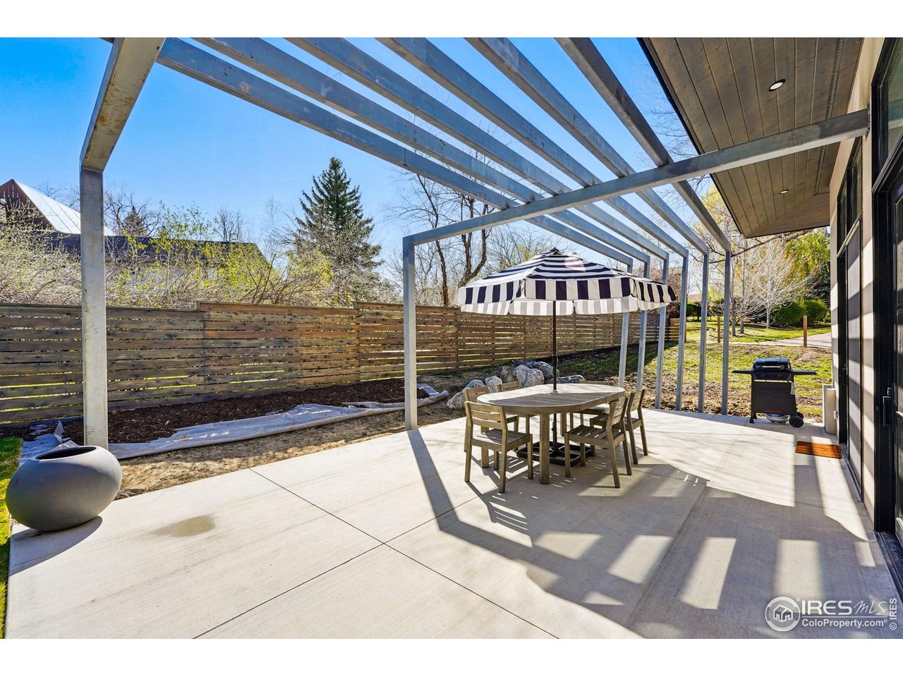6923 Hunter Place Boulder, CO 80301 - Photo 31 of 34 a view of a patio with table and chairs and floor to ceiling window