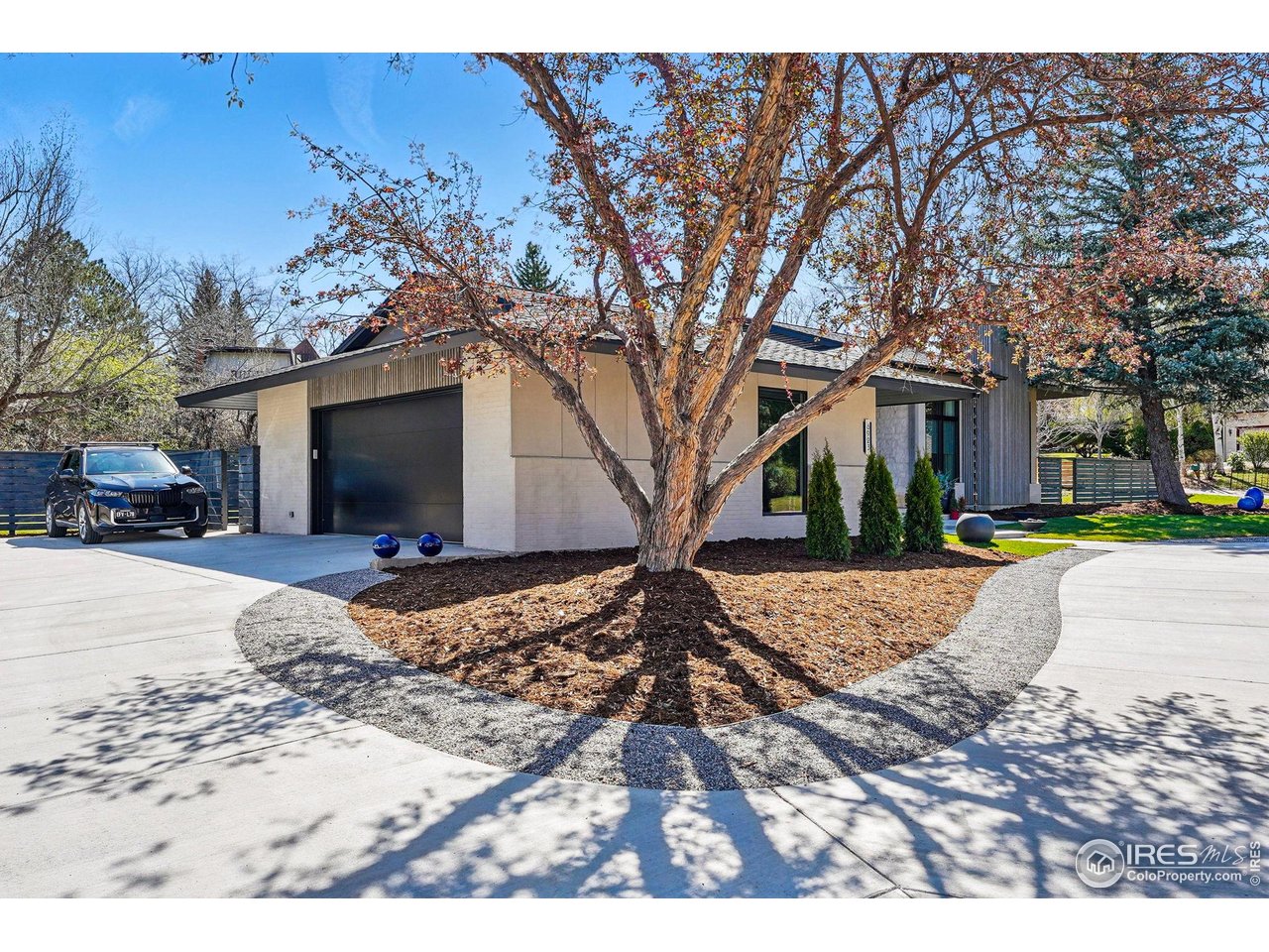 6923 Hunter Place Boulder, CO 80301 - Photo 4 of 34 a front view of a house with a yard covered with snow and trees