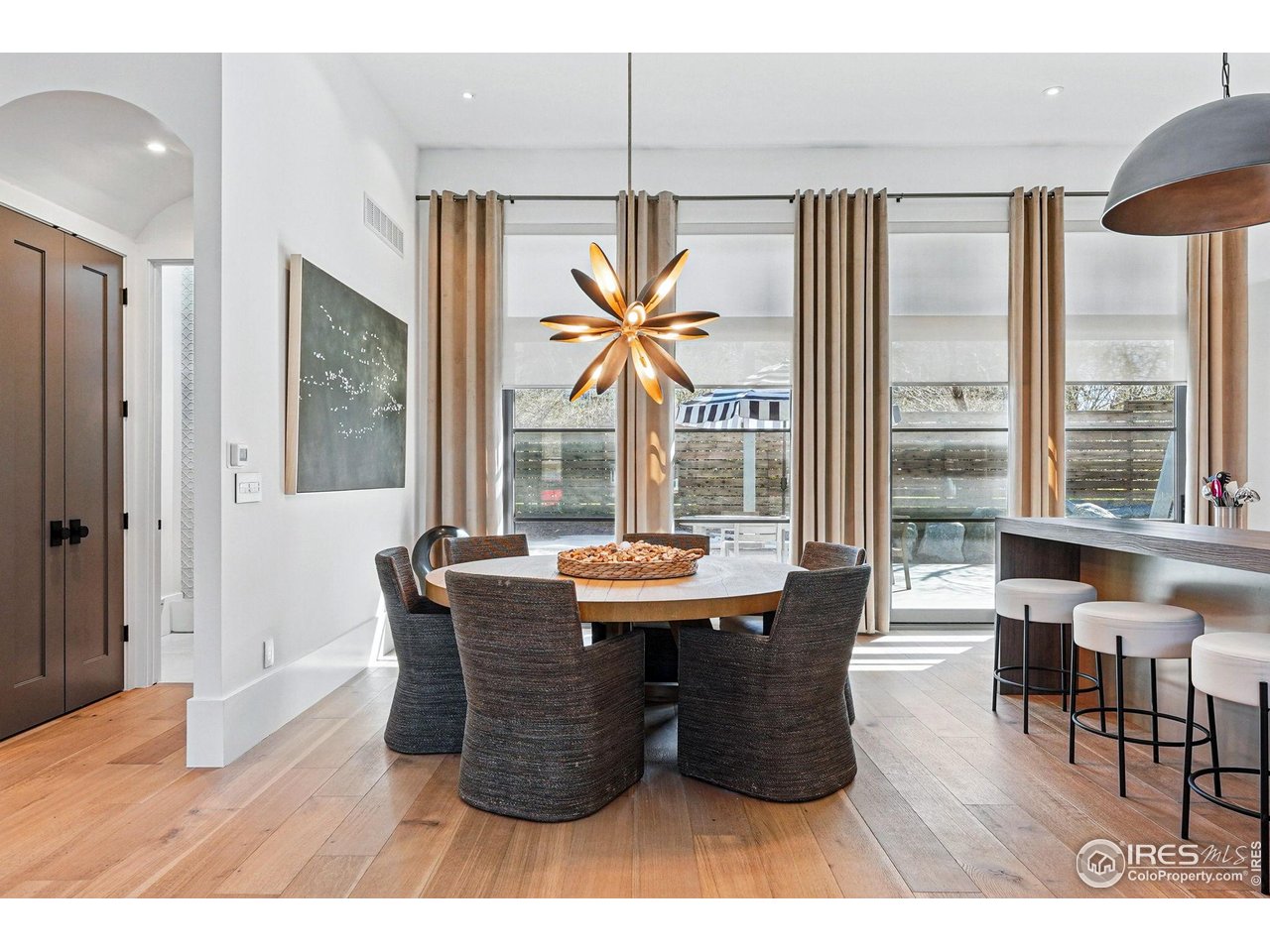 6923 Hunter Place Boulder, CO 80301 - Photo 10 of 34 a dining room with furniture wooden floor and a chandelier