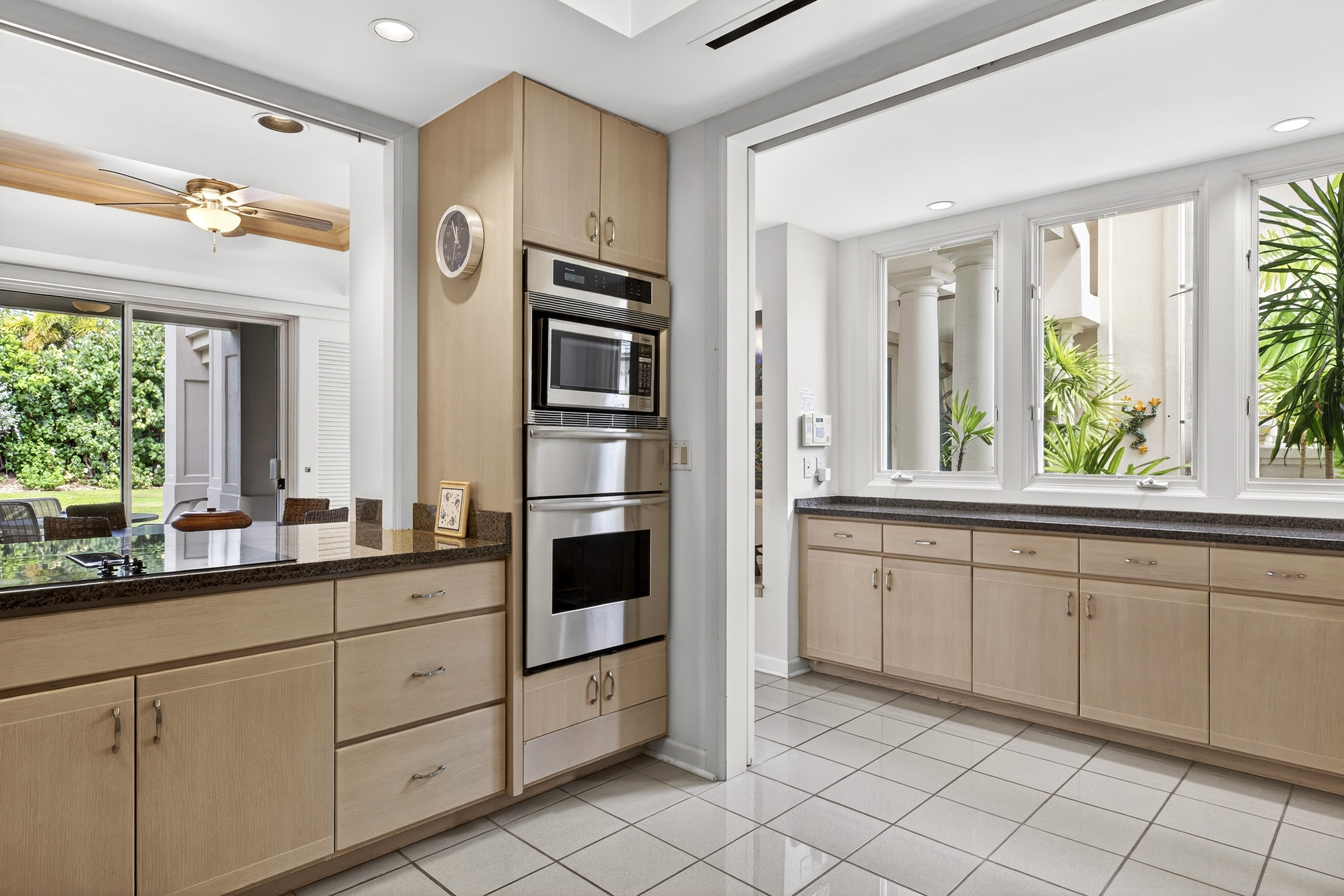 68-1375 Pauoa Road, Unit Q2 Kamuela, HI 96743 - Photo 8 of 30 a kitchen with granite countertop white cabinets and white appliances