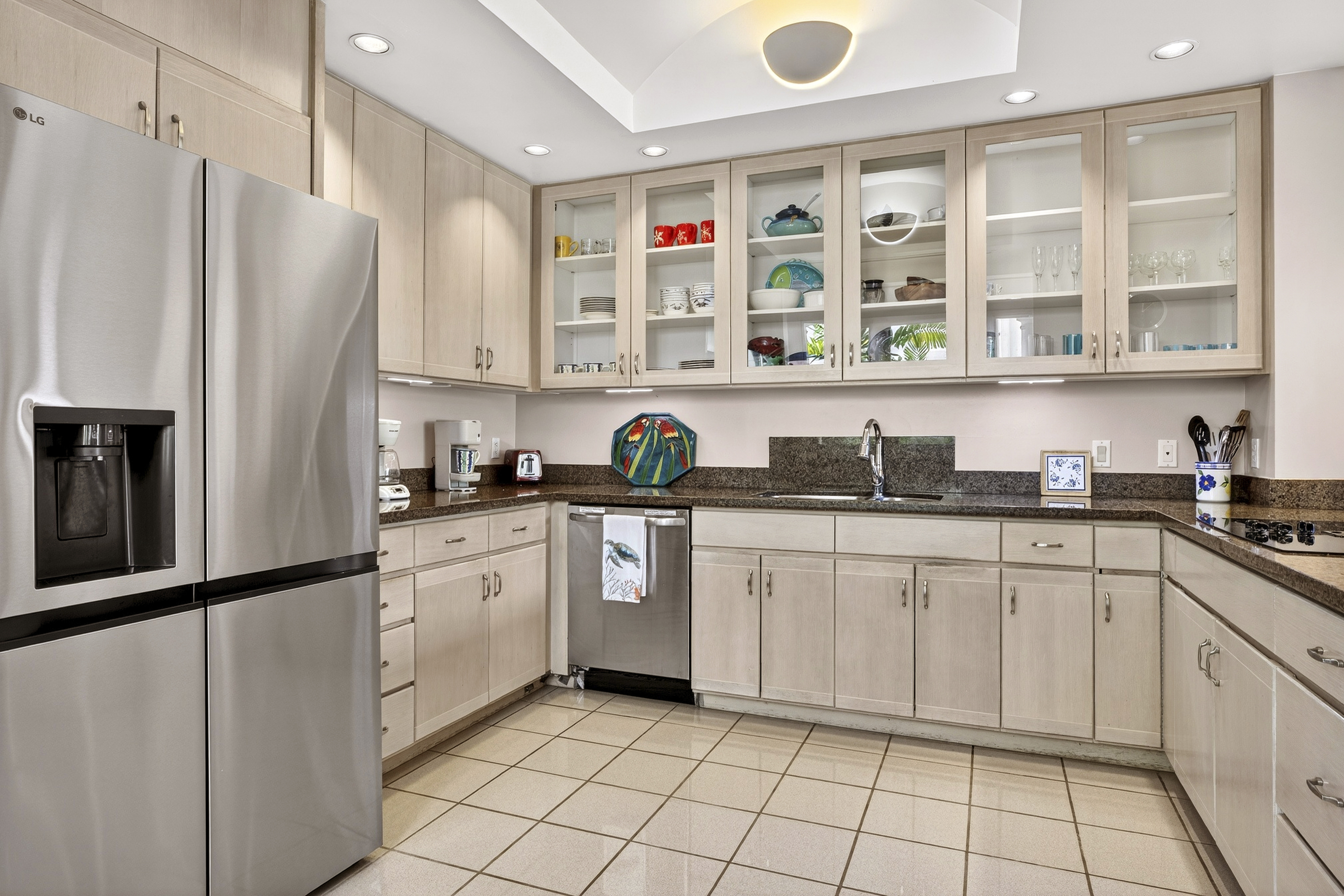 68-1375 Pauoa Road, Unit Q2 Kamuela, HI 96743 - Photo 9 of 30 a kitchen with stainless steel appliances a refrigerator sink and cabinets