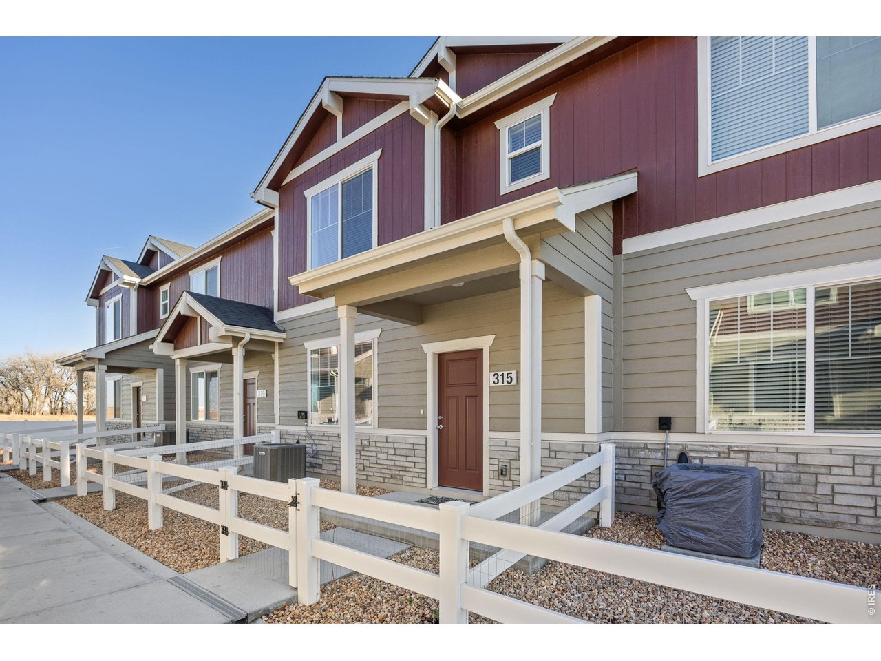 315 Condor Way Johnstown, CO 80534 - Photo 1 of 25 front view of a house with a bench