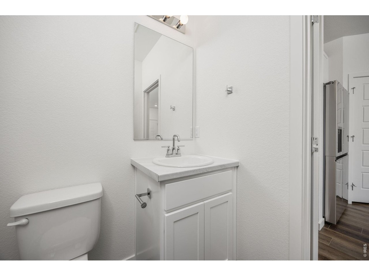 315 Condor Way Johnstown, CO 80534 - Photo 11 of 25 a bathroom with a sink a toilet and a mirror