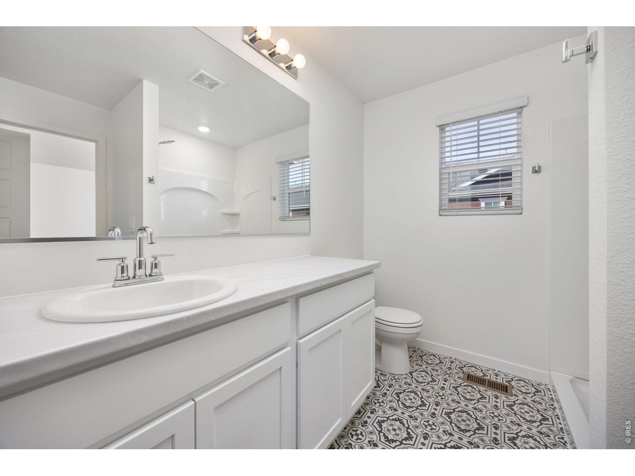 315 Condor Way Johnstown, CO 80534 - Photo 15 of 25 a bathroom with a granite countertop sink a toilet and a mirror