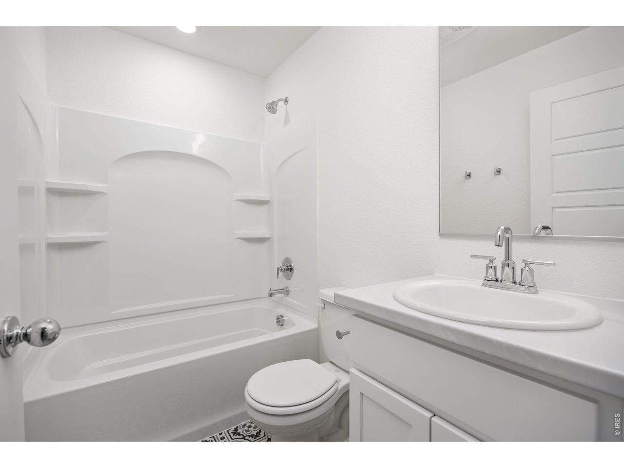 315 Condor Way Johnstown, CO 80534 - Photo 18 of 25 a bathroom with a sink toilet a mirror and shower