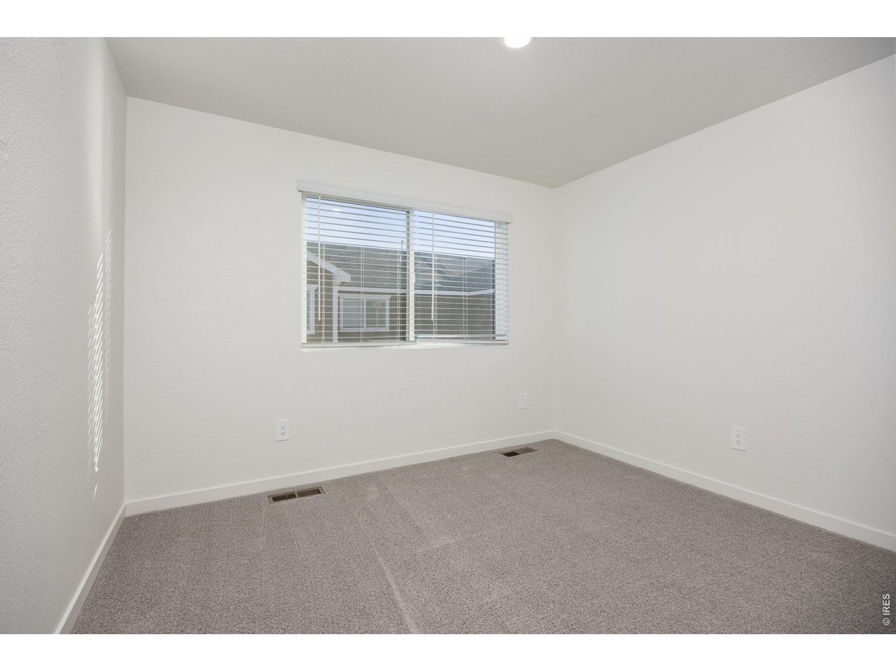 315 Condor Way Johnstown, CO 80534 - Photo 21 of 25 an empty room with wooden floor and windows