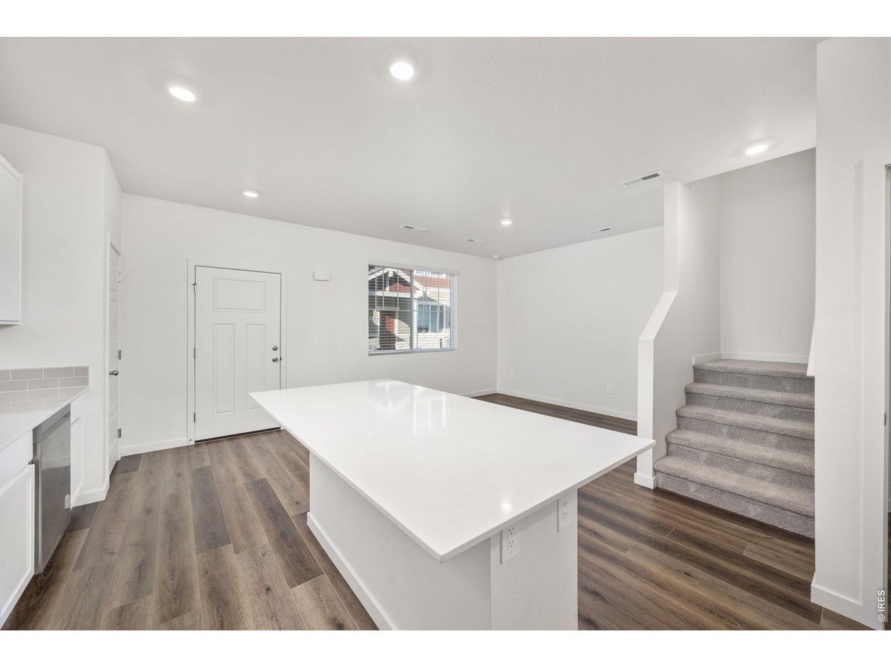 315 Condor Way Johnstown, CO 80534 - Photo 10 of 25 a view of kitchen and hall with wooden floor