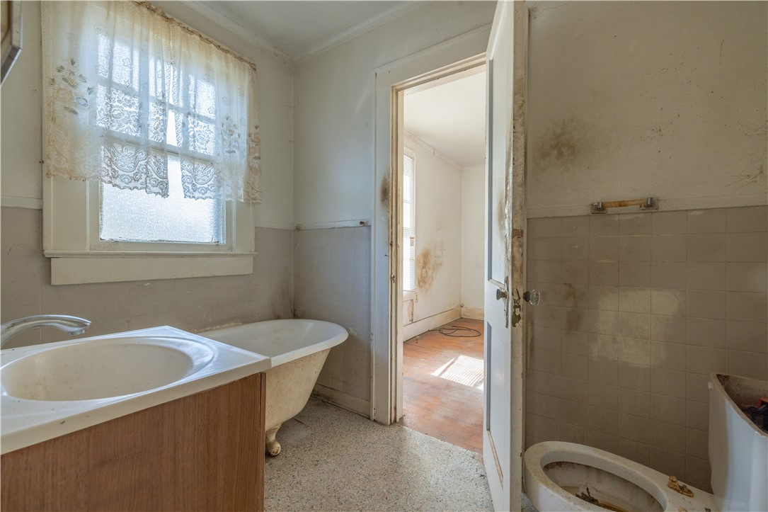 106 Frances Street Anderson, SC 29621 - Photo 9 of 15 This bathroom is inbetween bedrooms 1 and 2 and features a classic claw-foot tub, a single vanity, and a window for natural light.