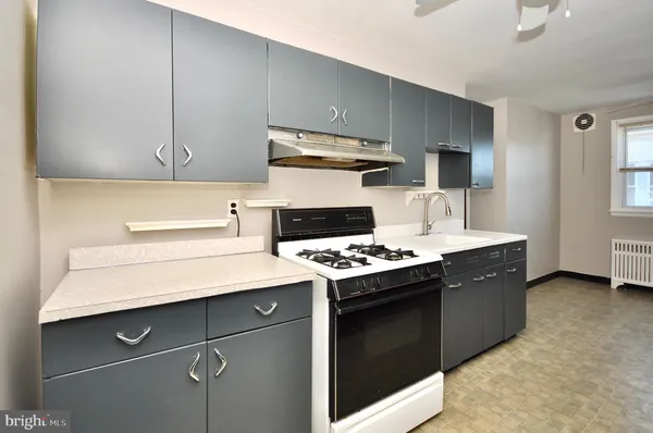 a kitchen with a stove and a sink