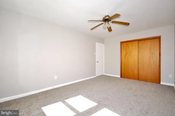 a view of a room with a window and a ceiling fan