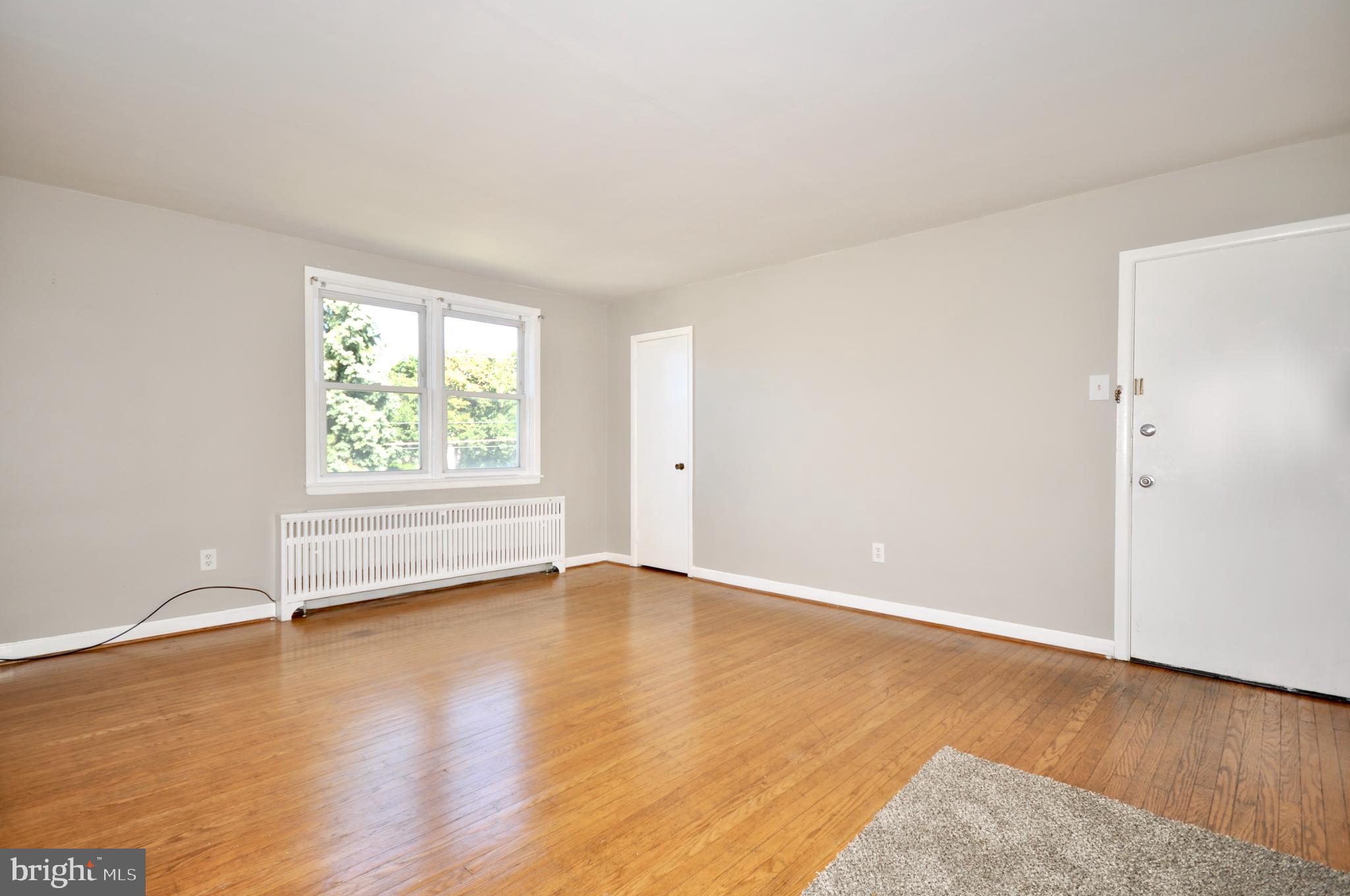 8035 Pine Road Philadelphia, PA 19111 - Photo 4 of 23 an empty room with wooden floor and windows