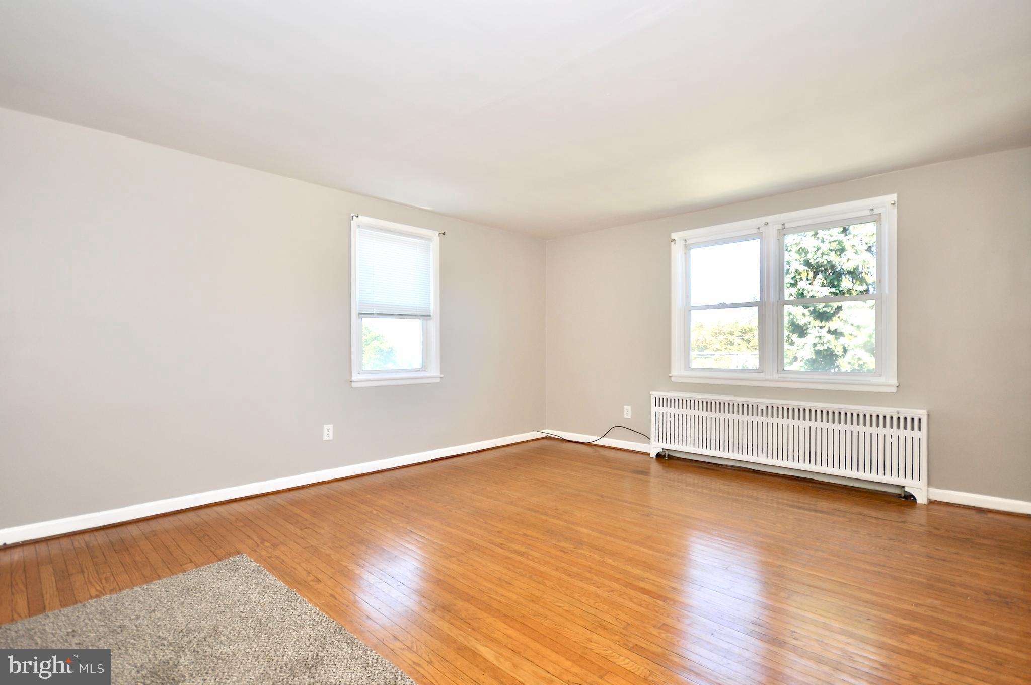 8035 Pine Road Philadelphia, PA 19111 - Photo 7 of 23 an empty room with wooden floor and windows