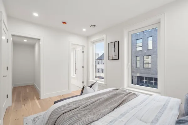 a bedroom with a bed and a window