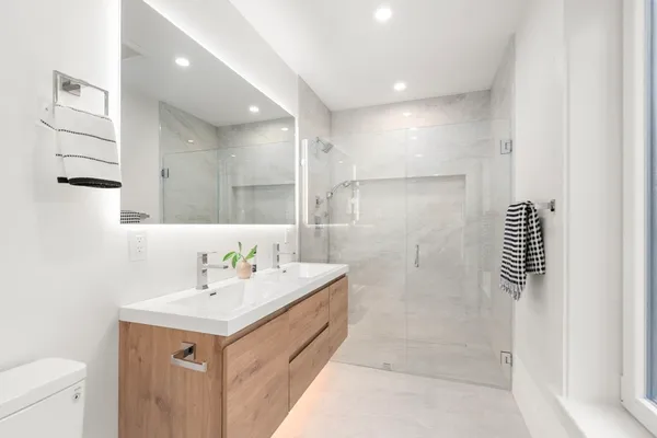 a bathroom with a sink a toilet and shower