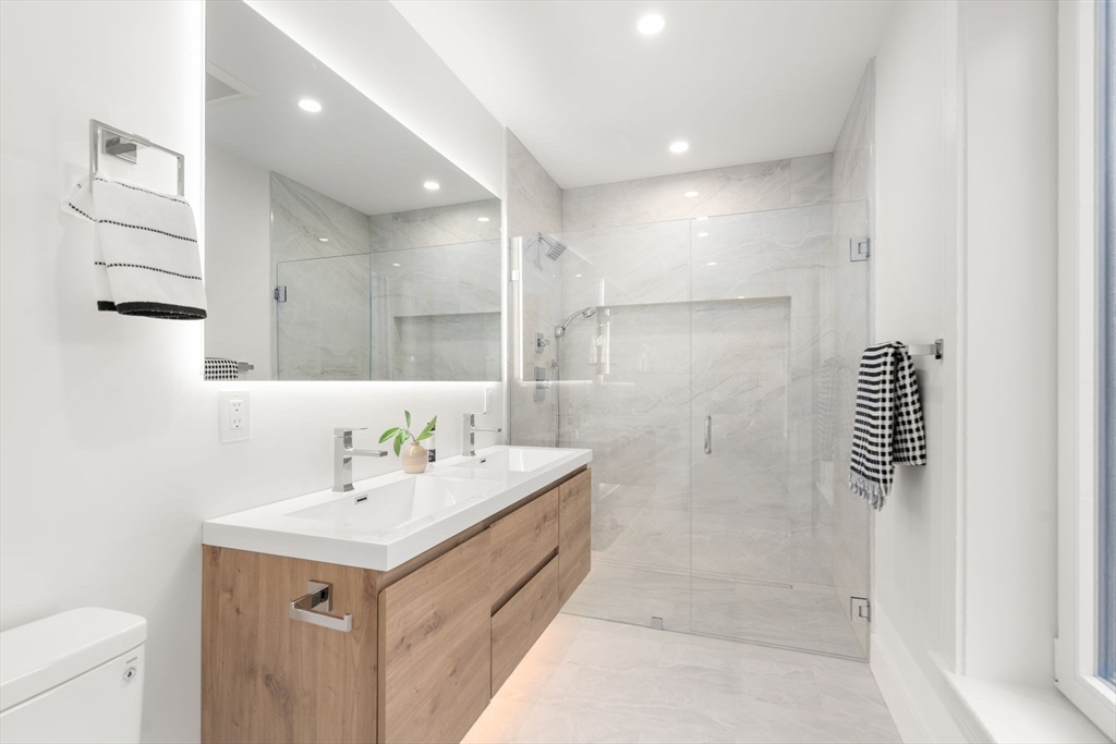 90 A Street, Unit 3 Boston, MA 02127 - Photo 16 of 20 a bathroom with a sink a toilet and shower