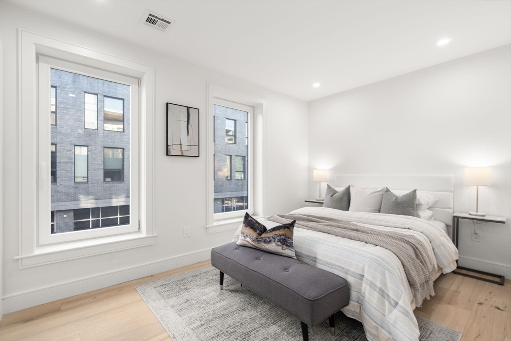 90 A Street, Unit 3 Boston, MA 02127 - Photo 17 of 20 a spacious bedroom with a bed and wooden floor