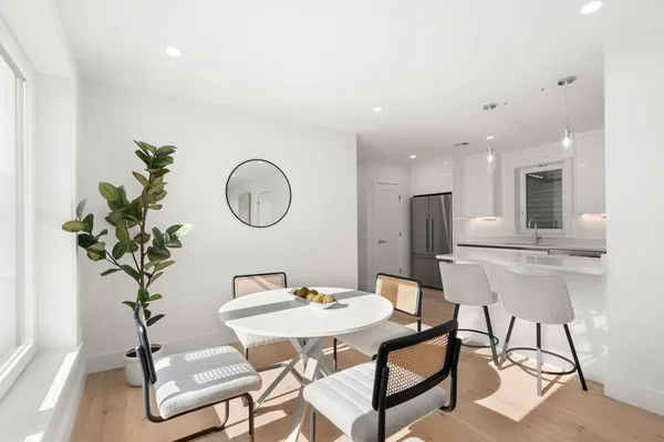 a dining room with furniture and a potted plant