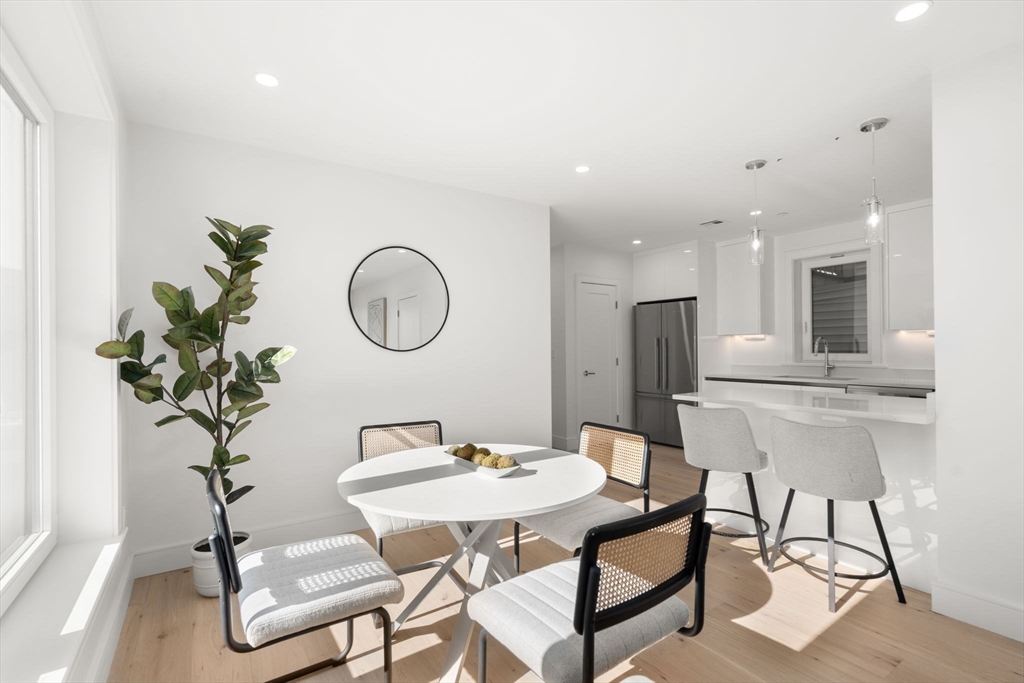 90 A Street, Unit 3 Boston, MA 02127 - Photo 3 of 20 a dining room with furniture and a potted plant