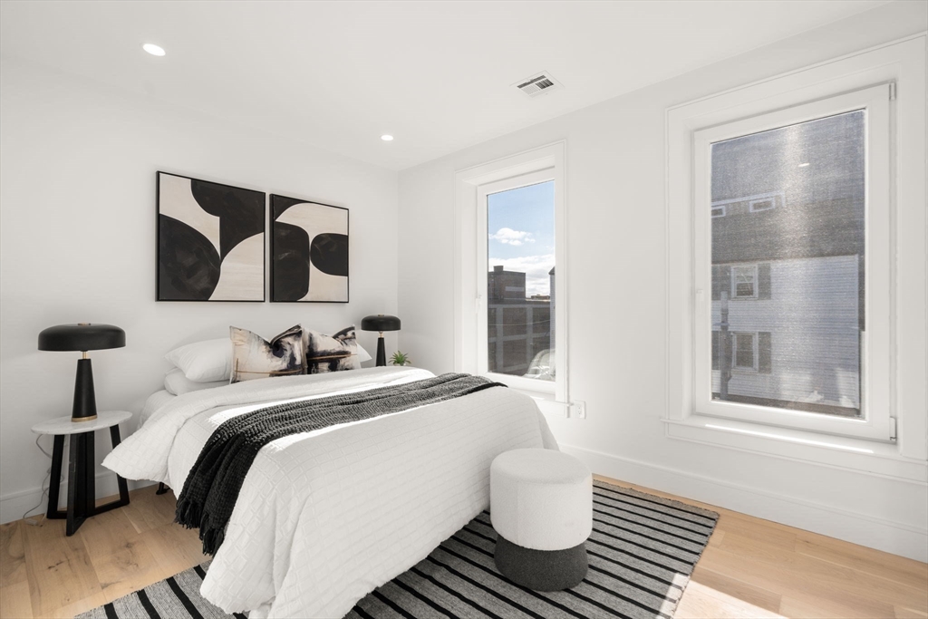 90 A Street, Unit 3 Boston, MA 02127 - Photo 9 of 20 a bedroom with a bed and wooden floor