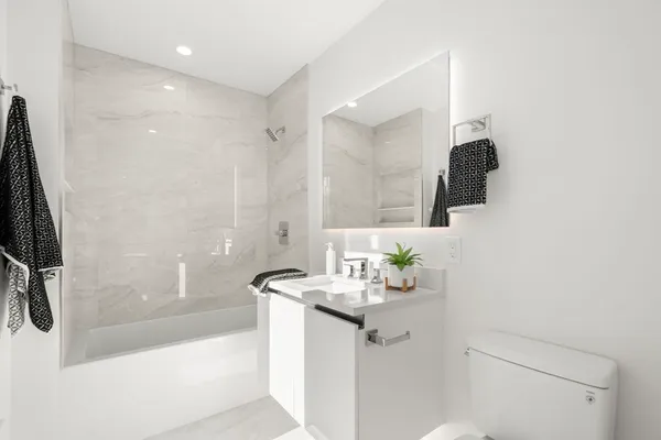 a bathroom with a sink a mirror and a bathtub