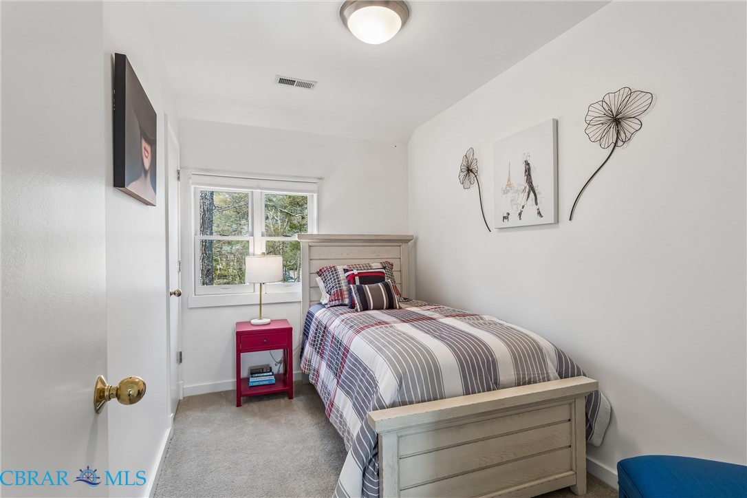 172 Sturgeon Creek Road Deltaville, VA 23043 - Photo 26 of 50 Guest Bedroom featuring light carpet and baseboards