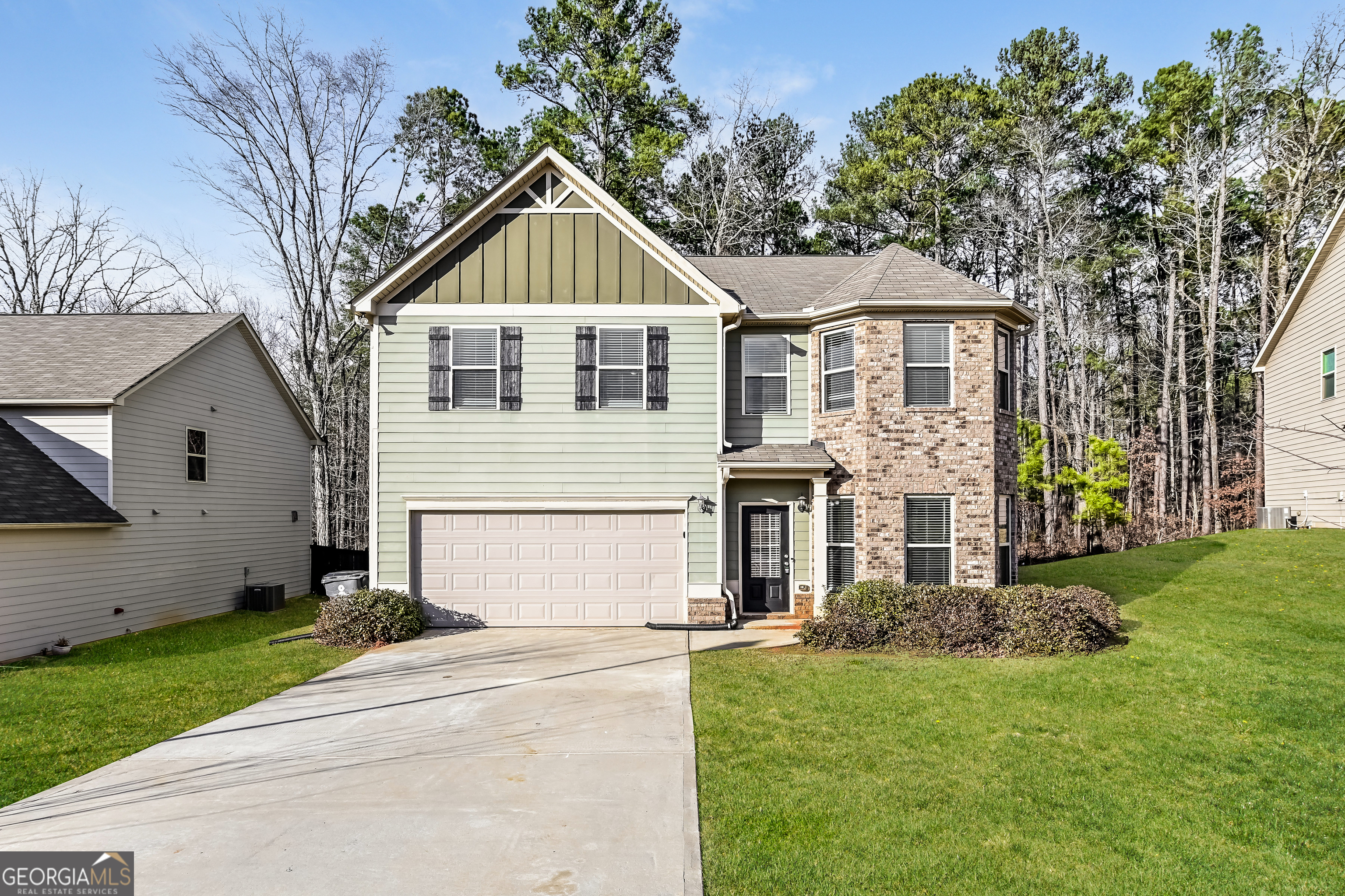 a front view of a house with a yard and garage